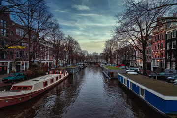 AMSTERDAM, NETHERLANDS - Dec 06, 2019: Canal in Amsterdam after sunset