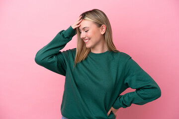 Young caucasian woman isolated on pink background smiling a lot