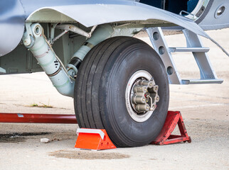 Close up detail with a landing gear of a airplane. Aircraft tires wheels