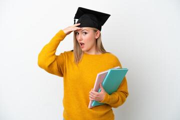 Young student caucasian woman isolated on white background doing surprise gesture while looking to the side