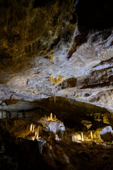 Bizarre and fabulous karst deposits, stalactites and stalagmites, like candles, in the New Athos Cave in Abkhazia