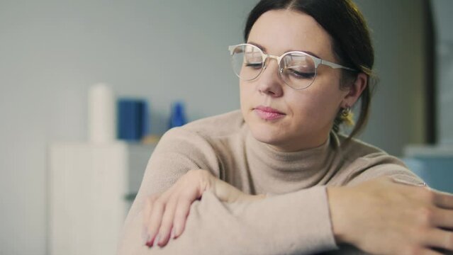 Upset lonely woman leaning head on hands and dreaming looking at window memories