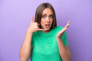 Fototapeta na wymiar Young caucasian woman isolated on purple background making phone gesture and doubting
