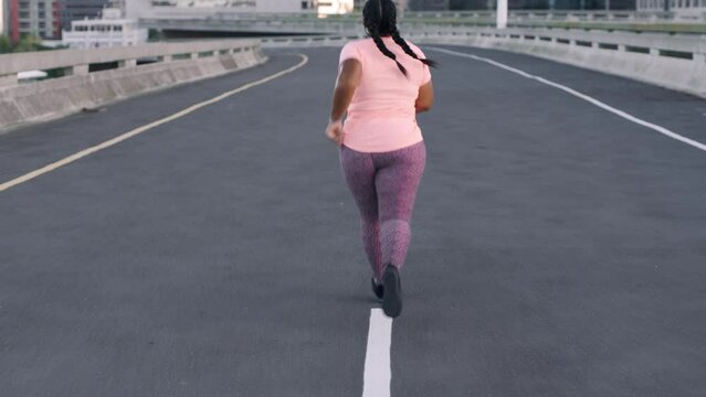 Fitness, freedom and black woman running in city street for health and weight loss. Exercise, motivation and plus size woman runner training in cardio, strength and body care on healthy urban workout