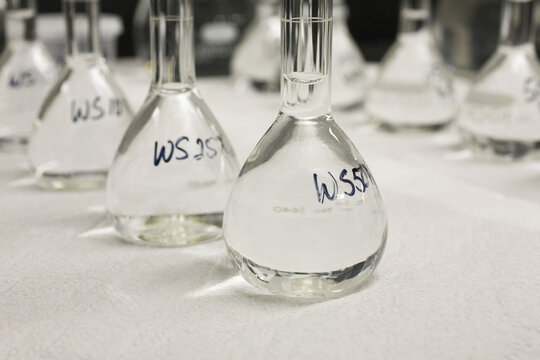 Close-up of volumetric flasks in a row