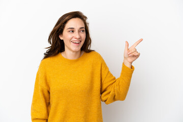 Young caucasian woman isolated on white background intending to realizes the solution while lifting a finger up