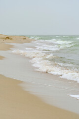 Beach Baltic Sea coast with quartz sand and rolling waves.