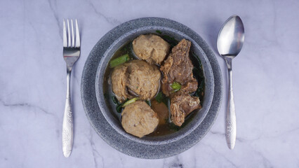 Image of Bakso Kuah/Meatball Soup on a marble texture background. Indonesian Traditional Food Top View