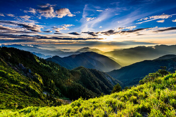 Layers of magnificent mountains at sunset with the sea of clouds background in Hehuanshan, Taiwan.
