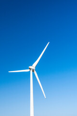 Close-up of wind power systems with the blue sky background.