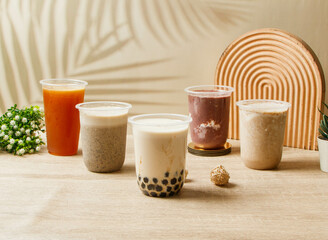 assorted tea Red bean and purple rice, mung bean paste milk, black sesame, pearl black sugar milk, Hong Kong style lemon tea served in disposable glass top view of taiwan drink