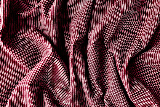 Color of the year 18-1750 Viva Magenta color. Striped fabric. Cotton, bedding, blue and white stripes on the fabric. Texture. Background.