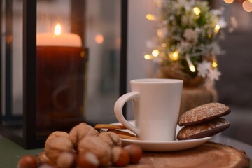 cup of coffee and cookies at cozy christmass lights