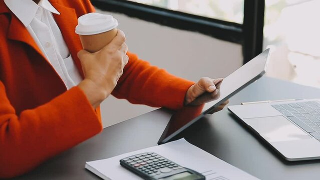 Businessman and team analyzing financial statement Finance task. with smart phone and laptop and tablet. Wealth management concept