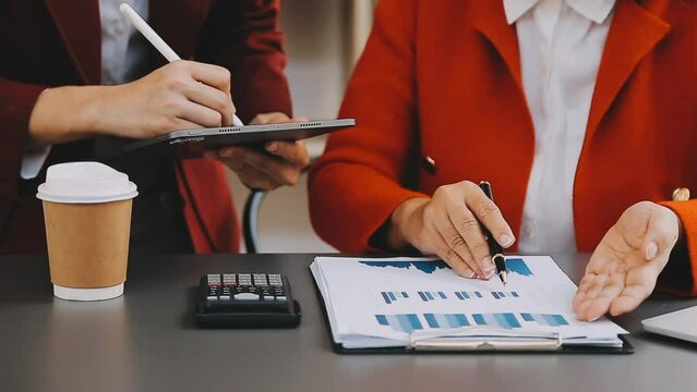 Businessman and team analyzing financial statement Finance task. with smart phone and laptop and tablet. Wealth management concept