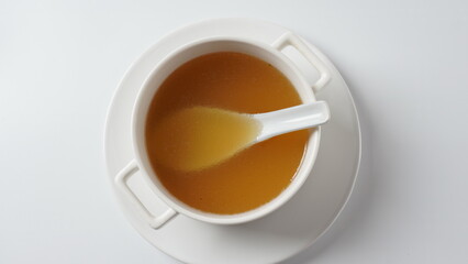 Chicken bone broth in a white soup bowl