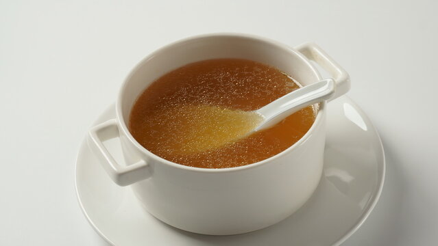 Chicken bone broth in a white soup bowl