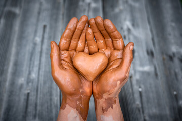 Heart made of potter's clay in the hands of a master potter. Love concept