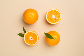 Flat lay with fresh oranges and leaves on color background