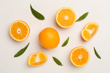 Fototapeta na wymiar Fresh oranges with leaves on concrete background