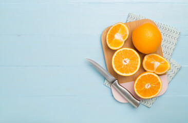 Flat lay with fresh oranges and leaves on wooden background
