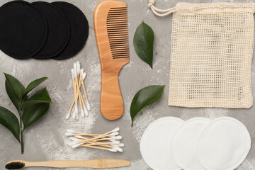 Flat lay with natural biodegradable accessories on concrete background, top view