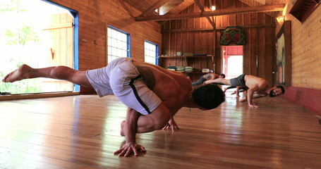 Yogi instructor teaching students advanced Yoga asana pose