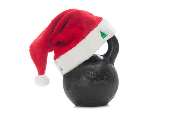 Santa Claus Hat worn on heavy kettlebell on white background. Christmas card