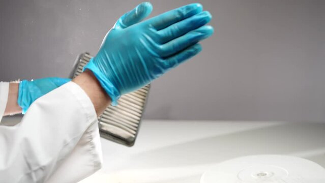 a very dirty and dusty air filter element in the hands of a specialist