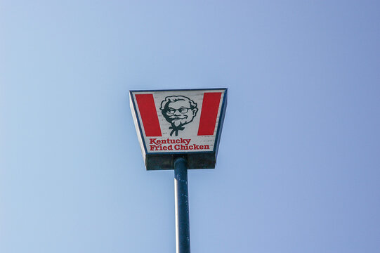 North Corbin, KY, USA – October 7, 2006: A Kentucky Fried Chicken sign stands against a blue sky at the Harlan Sanders Café and Museum in North Corbin, KY