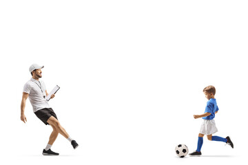Fototapeta na wymiar Football coach praticing ball kick with a boy