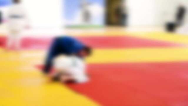 Judo competitions. Young athletes compete on the tatami. Judo. Blurred.