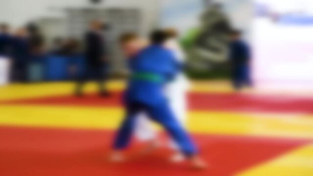 Judo competitions. Young athletes compete on the tatami. Judo. Blurred.