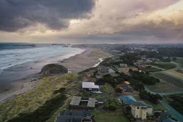 Storm clouds at sunset over homes at the Oregon Coast. 