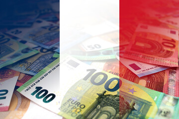 Euro banknotes background is colored in the colors of the French flag.