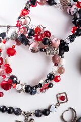  bracelets with black  semipreciouse stones with natural lava, shungite,  hematite,  around white background.  top view