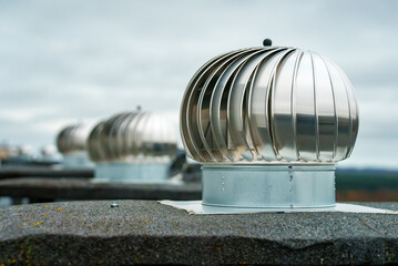 Rotary deflectors on the apartment house rooftop.