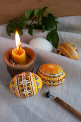 Fototapeta premium Ukrainian Easter eggs in yellow tones on the background of linen fabric