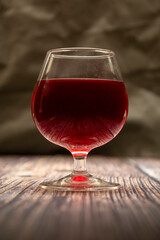 A glass of red wine on the table.