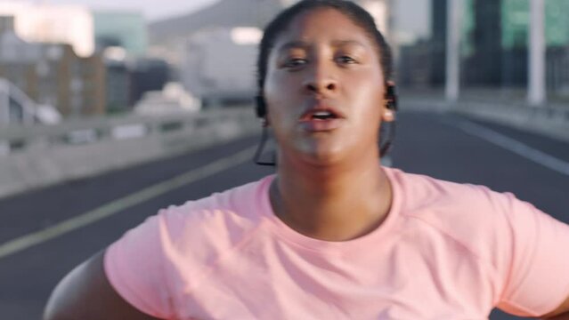 Running, tired and plus size woman on city road while listening to music for workout, exercise and cardio training to lose weight in obesity. Portrait and face of black female on break to breathe