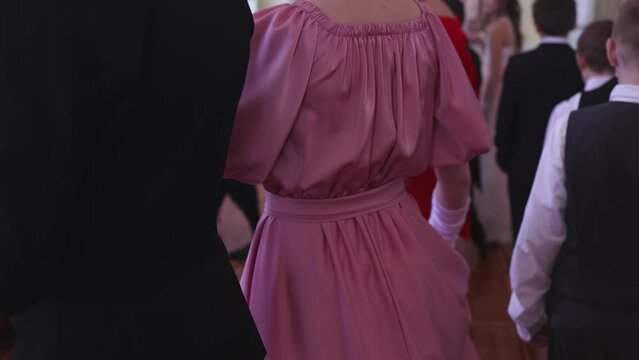 Couples dance on the historical costumed ball in historical dresses, classical ballroom dancers dancing, waltz, quadrille and polonaise in palace interiors on a wooden floor, charity event
