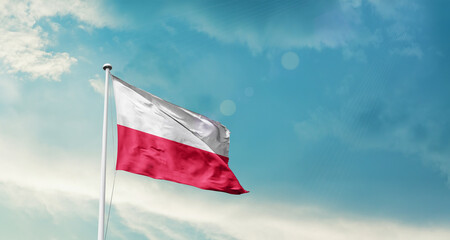 Waving Flag of Poland in Blue Sky. The symbol of the state on wavy cotton fabric.