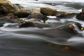 creek with soft flowing waterfalls and rocks