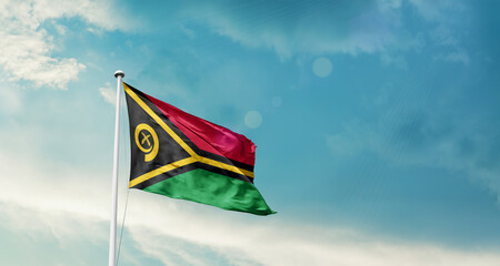Waving Flag of Vanuatu in Blue Sky. The symbol of the state on wavy cotton fabric.