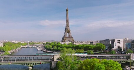 Drone view of the most popular attraction in the world in Paris. Drone flying near the eiffel tower in summer. The bridge of the old metro in the foreground - Powered by Adobe