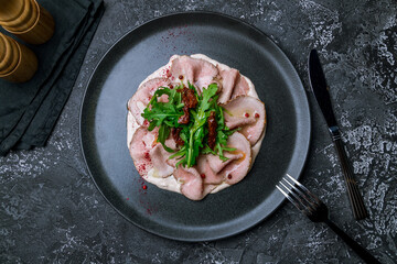 vitello tonato on a dark plate top view
