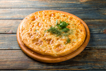 khachapuri with spinach and cheese on the board, georgian cuisine