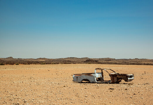 Abandoned shell of a car in the desert on the road to Brandberg Mountain, Damaraland; Kunene Region, Namibia