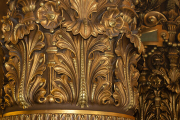 Close up of a golden Corinthian column 