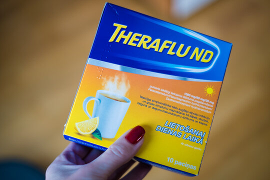 Tallinn, Estonia - December 16, 2022: Theraflu tea powder for flu treatment. Flu or common cold medicine for home use.